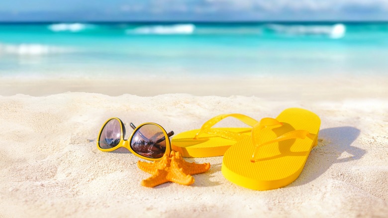 Flip-flops and sunglasses on a beach