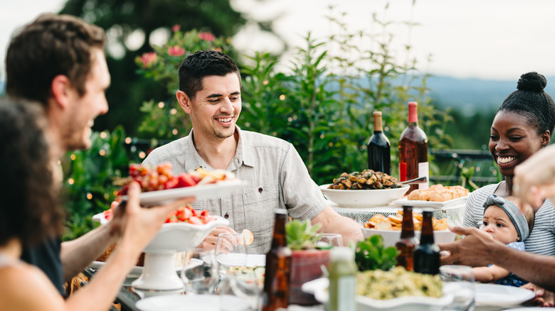 Adults enjoying an outdoor meal