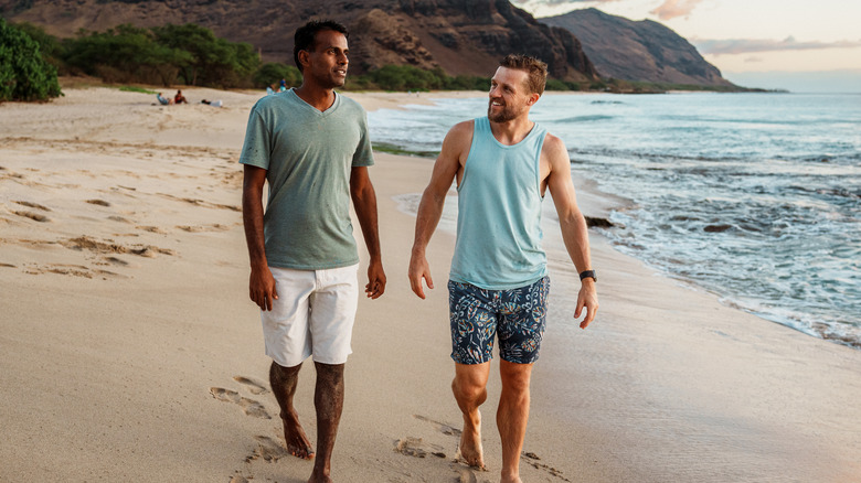 men walking on a Hawaiian beach