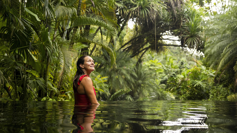 Woman swimming in the jungle of Costa Rica