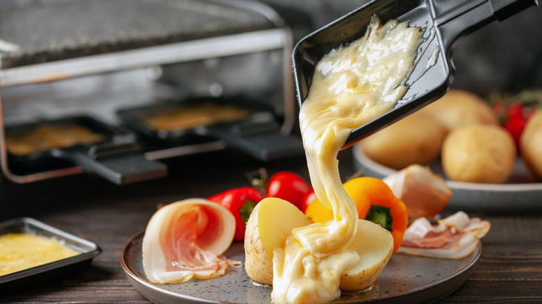 Raclette being poured over vegetables