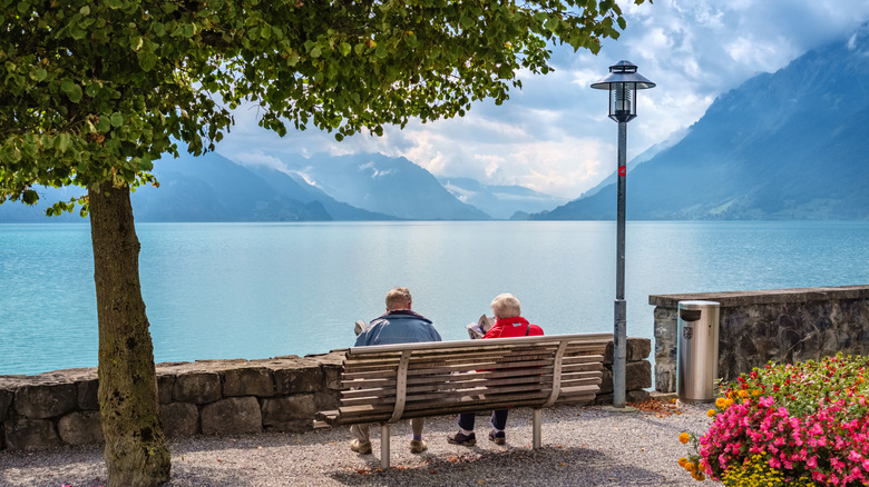 Elderly couple sitting by Lake Brienz