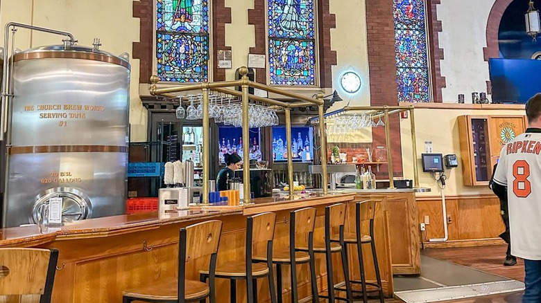 The inside bar, brewing tank, and stained glass at The Church Brew Works