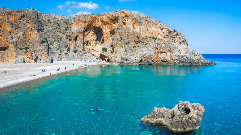 Panoramic view of Agiofarago Beach lined by rock formations