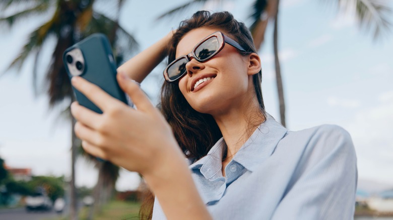 Female traveler looking at her cell phone