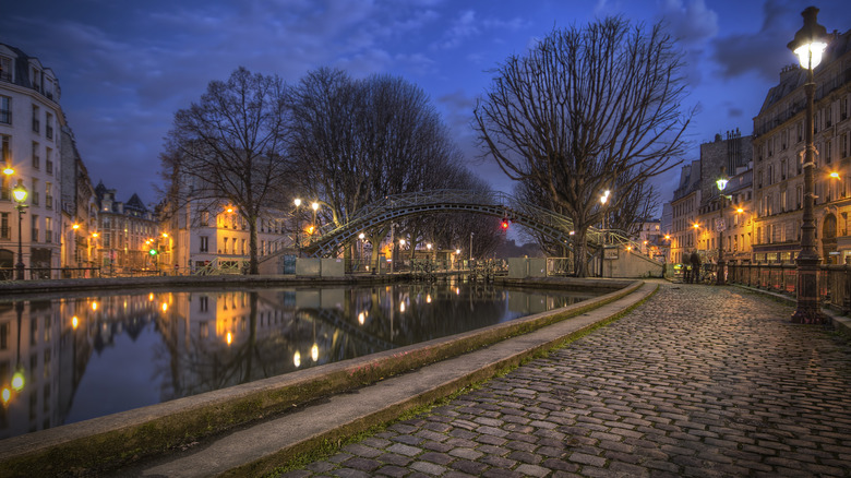 The Canal Saint-Martin at night with the streetlights lit up