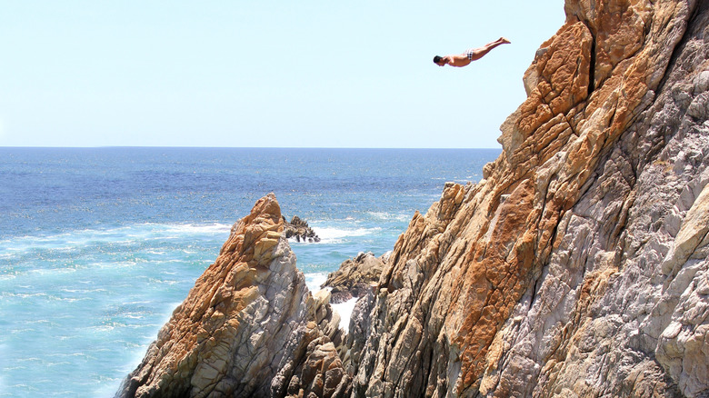 La Quebrada cliff diver jumps off the sea cliffs during a show in Mexico