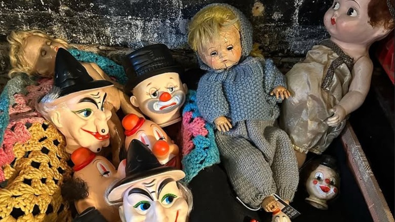 A collection of creepy baby and clown dolls