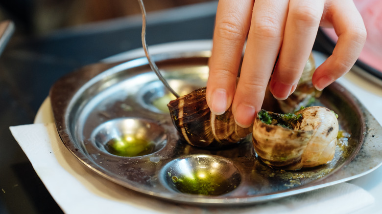 removing escargots from shell in french restaurant