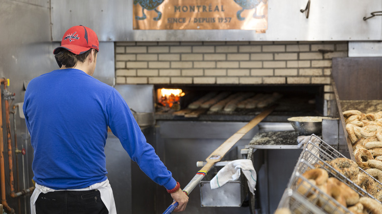 person making wood fired montreal bagels