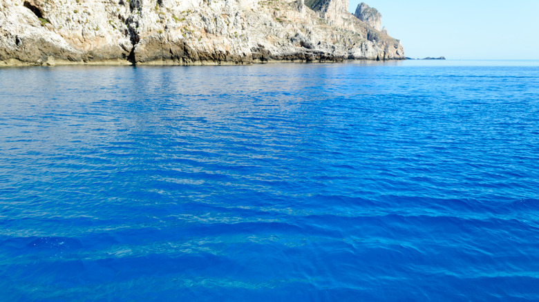 cobalt blue water and cliff