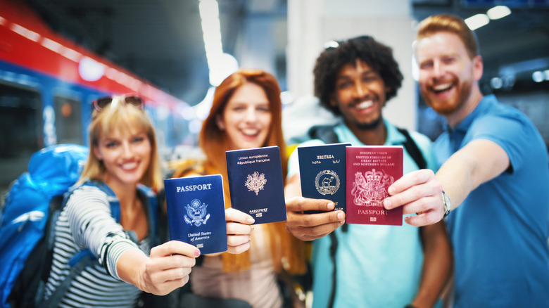 Group of travelers holding their passports