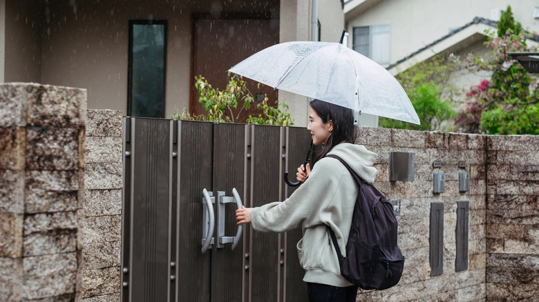 Person arriving at an Airbnb in the rain