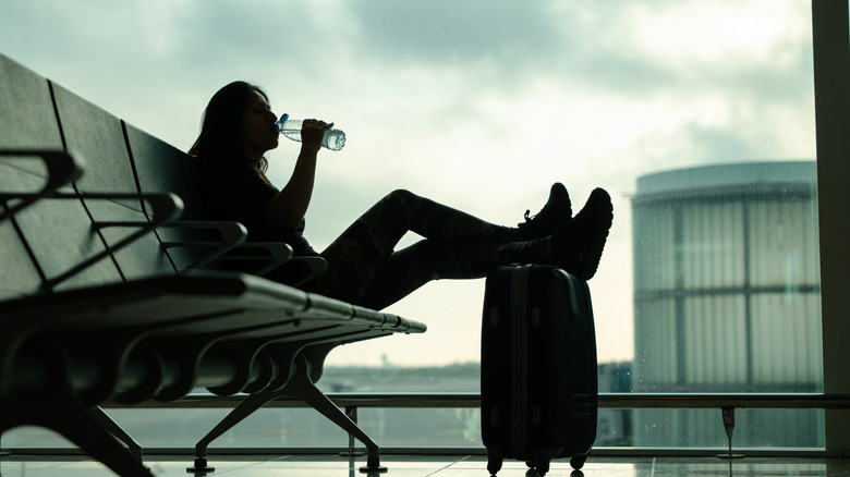 Person drinking water at airport