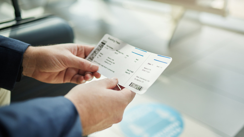 Person looking at plane ticket