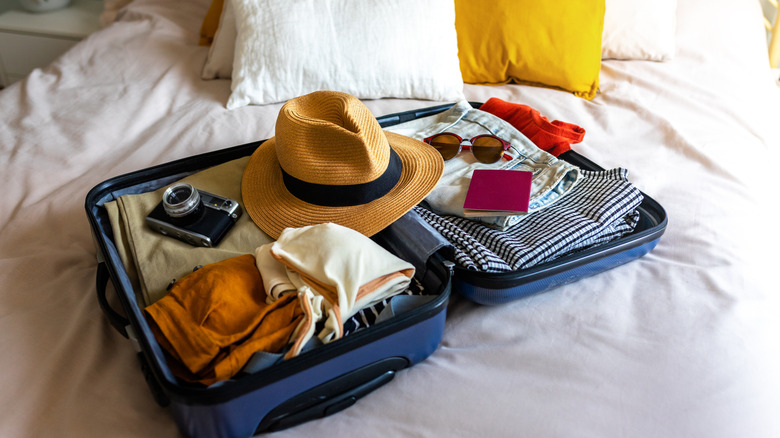 Suitcase on a hotel bed