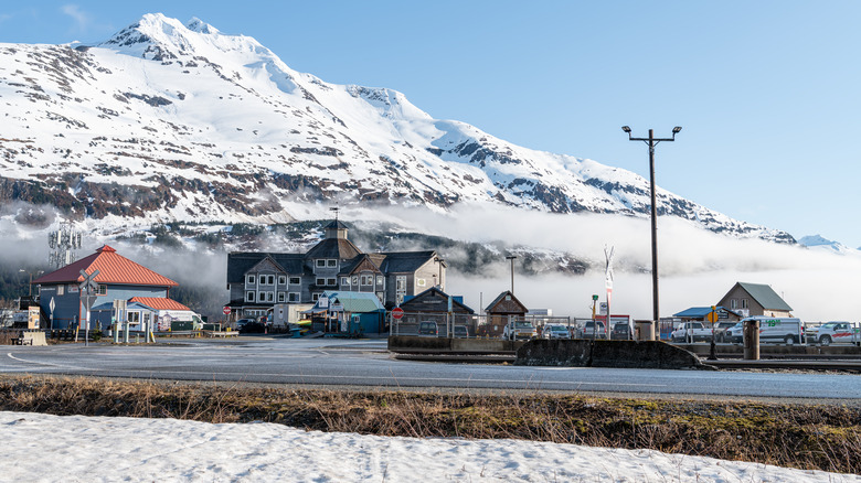 Whittier Alaska inn with snowy mountains in background