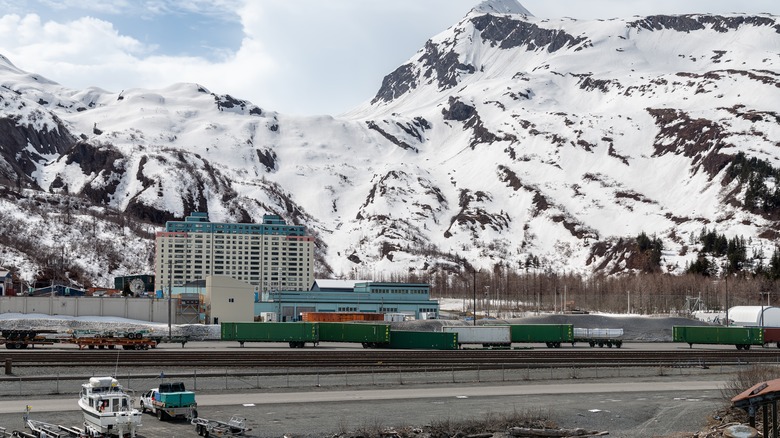 Begich towers with train and snowy mountains in Whittier Alaska