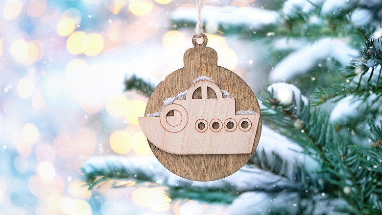 A cruise ship Christmas tree ornament hanging from a tree