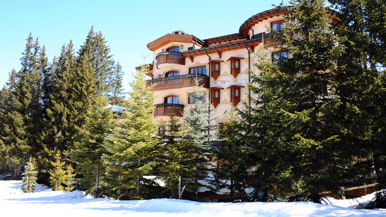 Facade of Airelles in Courchevel on ski slope with trees in Les Trois Vallée in France