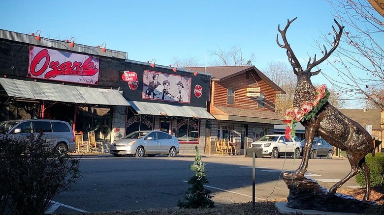 An elk statue with lights around it's neck in Jasper, Arkansas