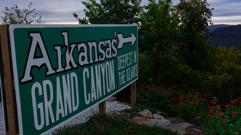 A green sign pointing to the Grand Canyon of Arkansas