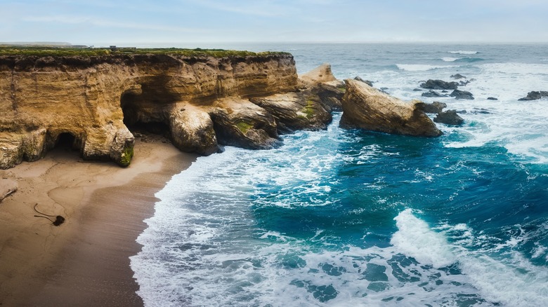 water hitting California beach cliffs