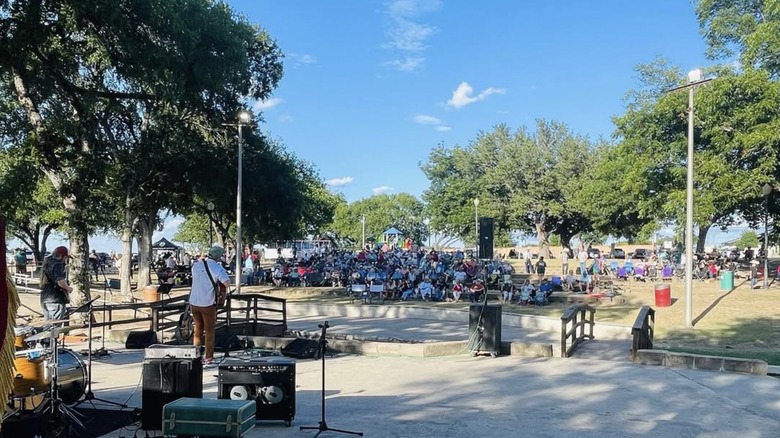 The Spring Ho Festival in Lampasas, Texas featuring a crowd of people listening to a band