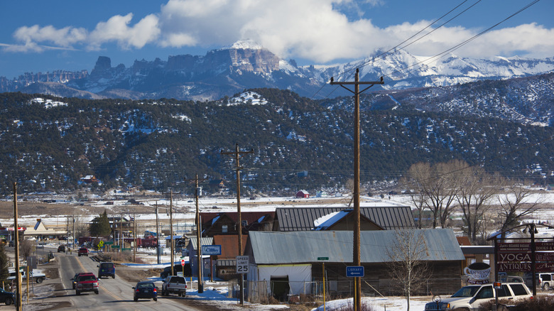 Town and road in Ridgway, Colorado, with snowy mountains in the distance