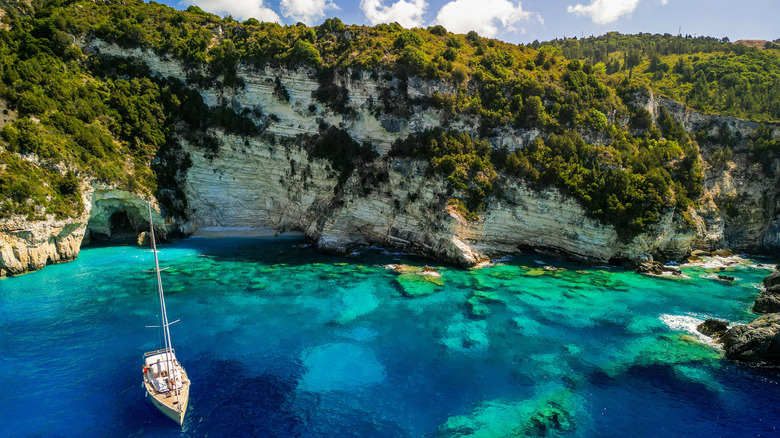 Small sailboat by an Antipaxos beach