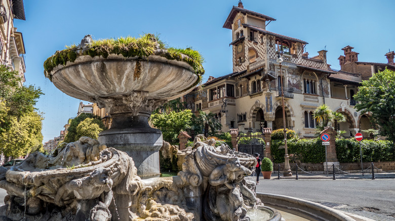 Ornate fountain with eclectic villa in the background