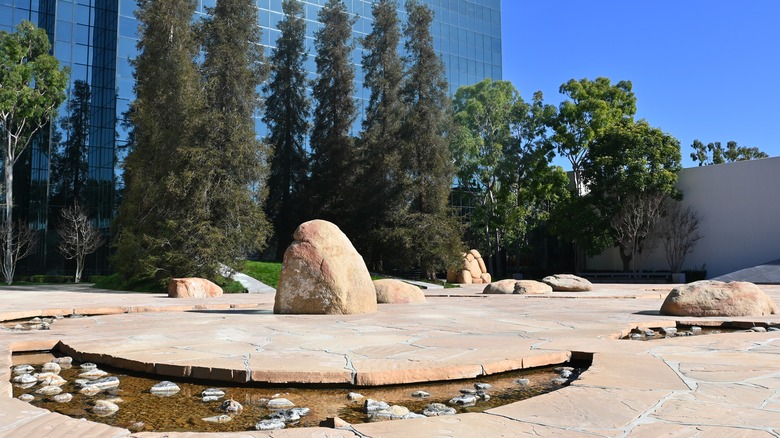 Minimalist sculptures in the Noguchi Garden with trees and glass skyscrapers