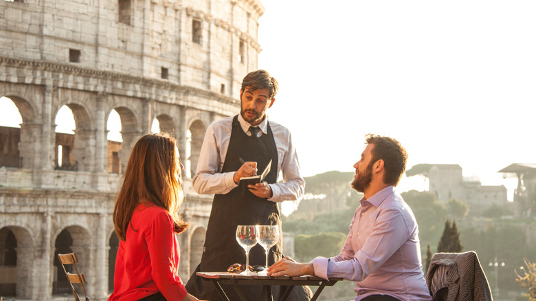 speaking to server at restaurant near Coliseum