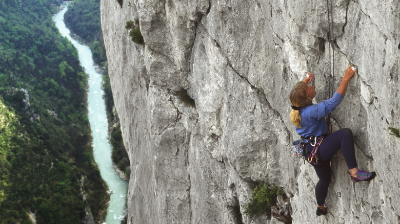 Climber climbing a cliff face