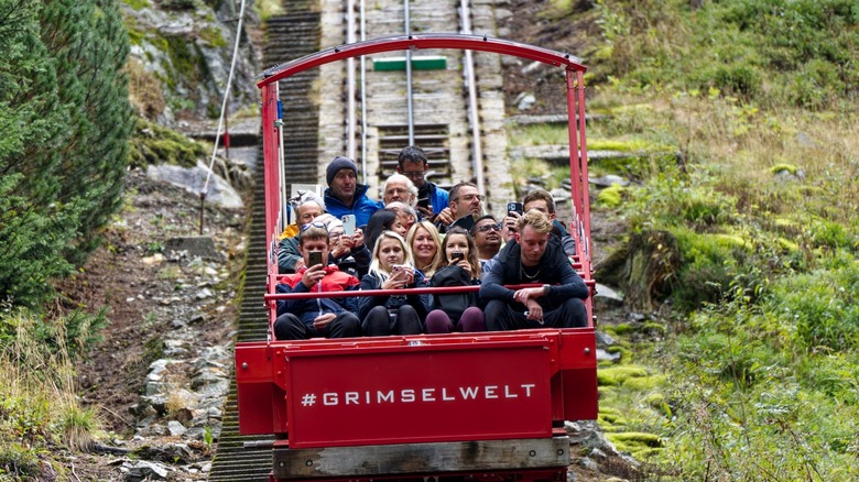 Close-up of tourists riding the Gelmerbahn funicular in Bern, Switzerland