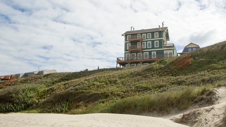 A view of the Sylvia Beach Hotel from the bottom of a hill on a cloudy day