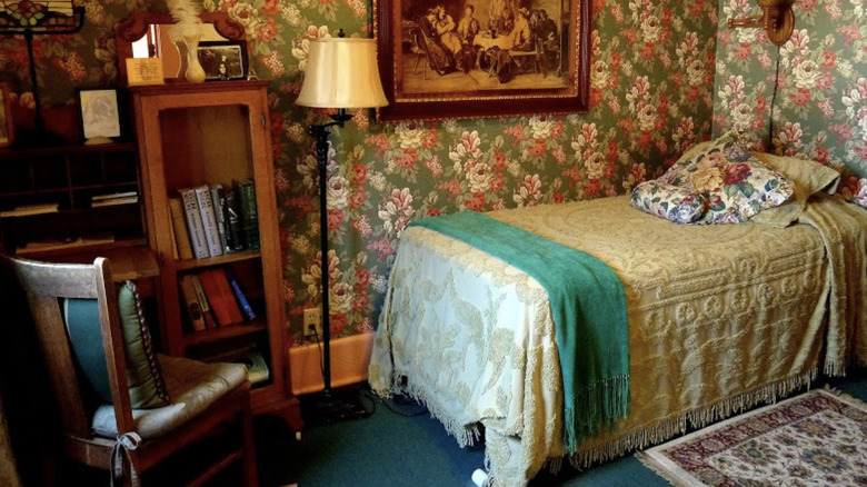 Oscar Wilde room at Sylvia Beach Hotel, with a small bed and floral wallpaper