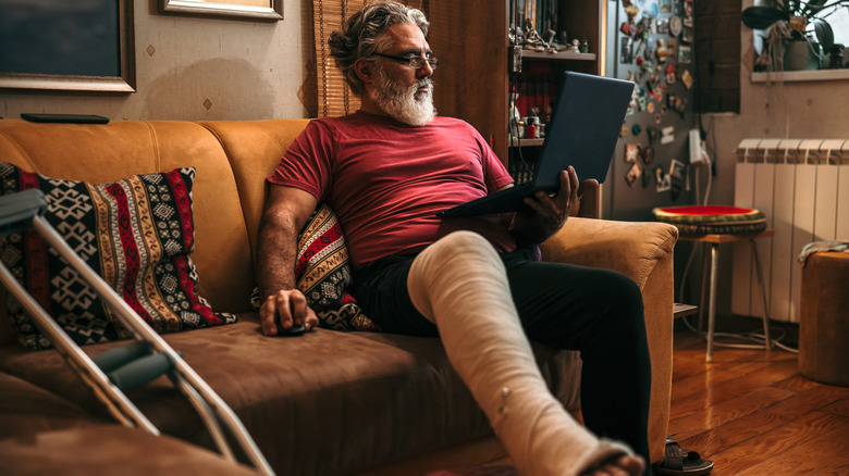 man with leg cast sitting