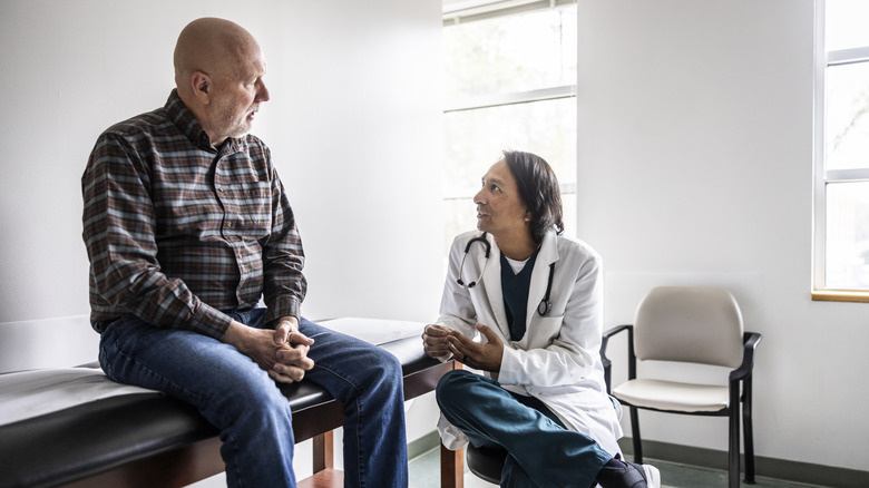 doctor speaking with elderly man