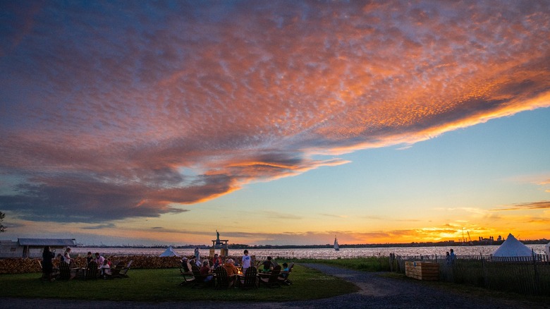 Sitting around fires at sunset on Governors Island