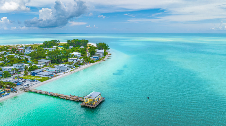 A pier at Anna Maria Island with cloudy blue skies