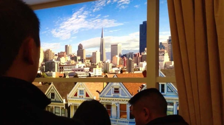 Three people at the Shake House, which has a digital video display of the Painted Ladies