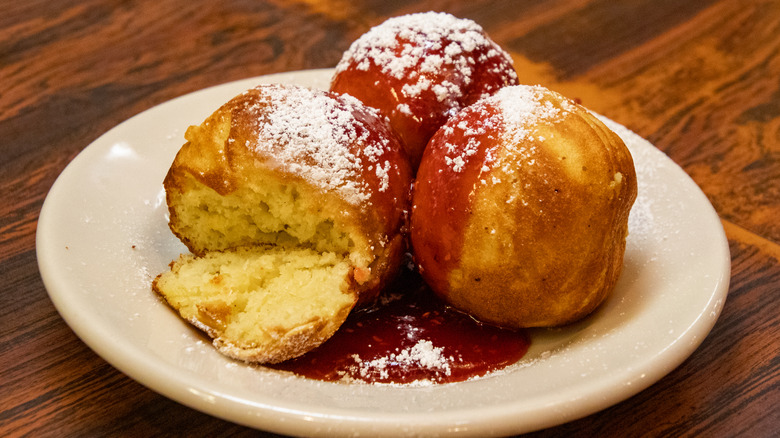 Aebleskivers on a plate with sauce