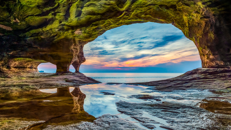 Sunset seen over a lake through sandstone archway