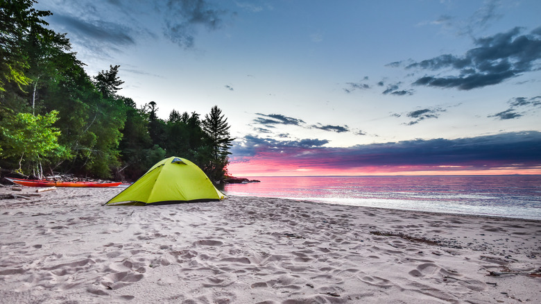 Green tent on a beach overlooking Lake Superior