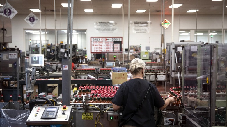 Woman works Tabasco bottling line Avery Island Louisiana