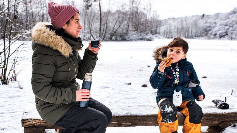 Mother and son enjoying fika in winter