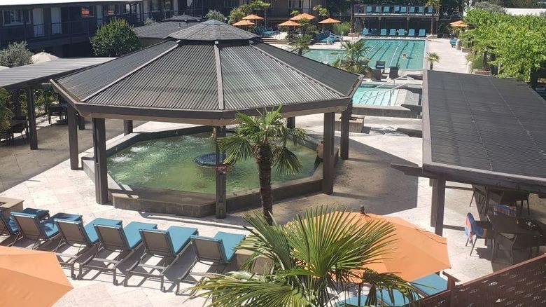 A view of Calistoga Spa Hot Springs with a pool and lounge chairs