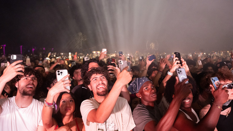 Festival attendees using their phones at Coachella 2024