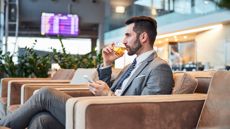 Man drinking alcohol at airport